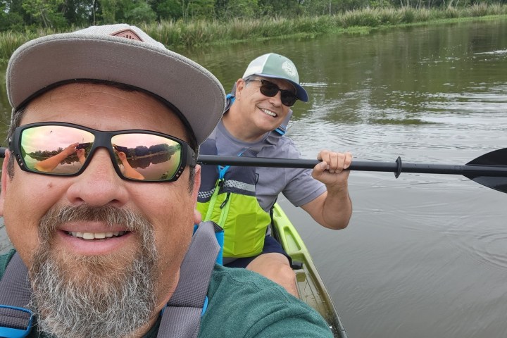 a man wearing a hat and sunglasses